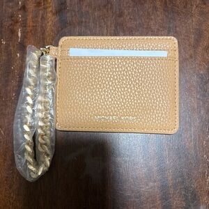 Michael Kors Jet Set Travel leather card holder featuring a goldtone wrist chain